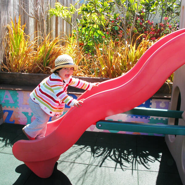 Child climbing on the outdoor slide