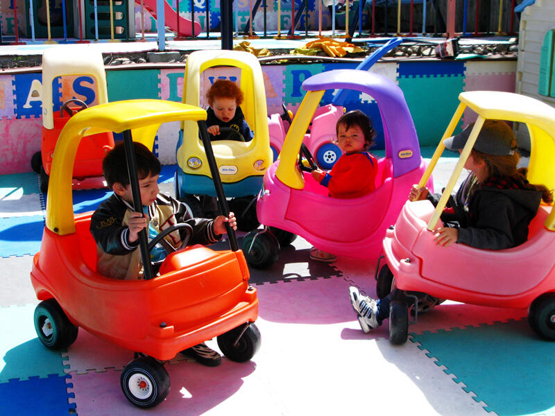 Untitled Children playing inside an outdoor playhouse