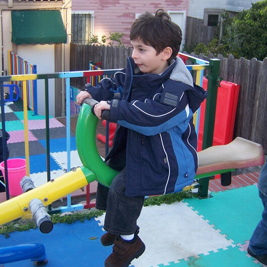 Child playing on outdoor playground equipment