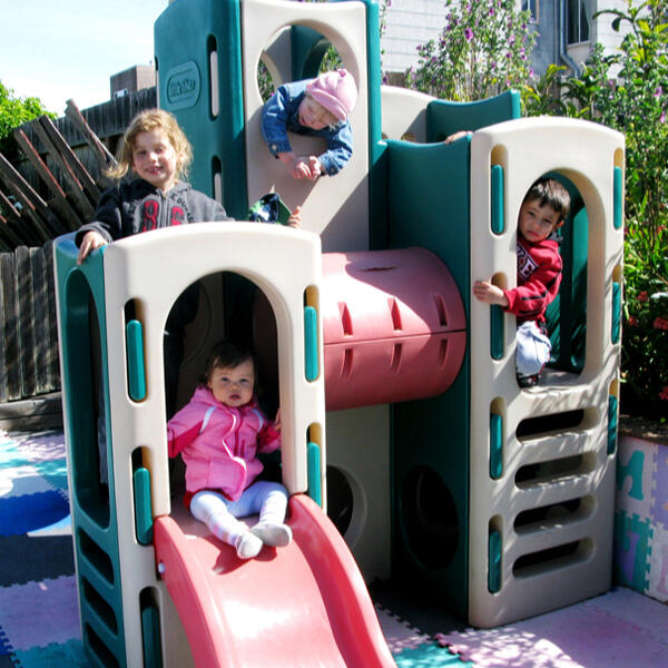 Children climbing and playing on the backyard structure