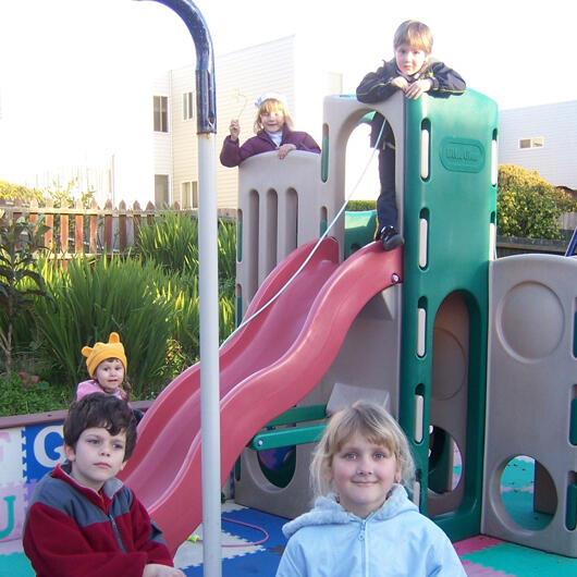 Untitled Children playing on the backyard slide