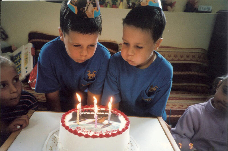 Child celebrating a birthday with cake and friends