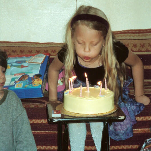 Child blowing out birthday candles