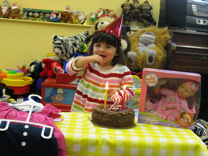 Child celebrating a second birthday with cake