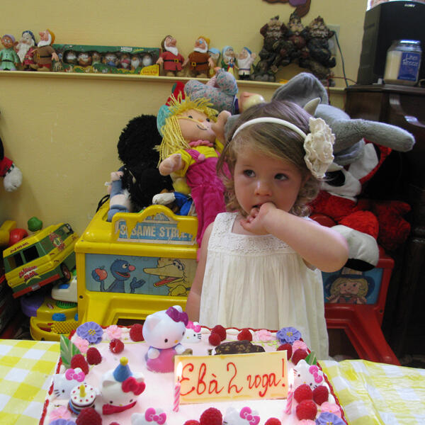 Untitled Child celebrating a 2nd birthday with cake and gifts