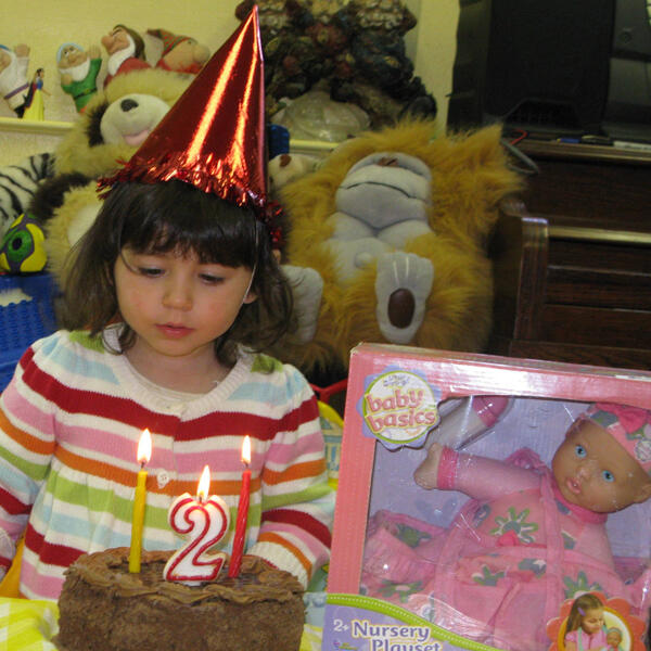 Untitled Child celebrating a second birthday with cake