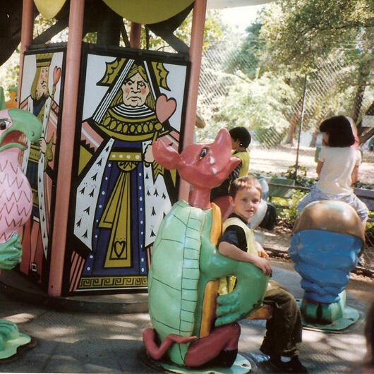 Child riding a dragon carousel figure