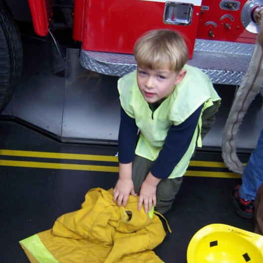 Child learning about firefighter gear
