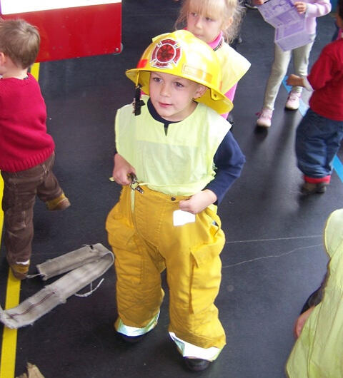 Child learning about firefighter gear