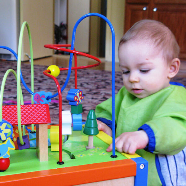 Untitled Infant exploring a colorful learning toy