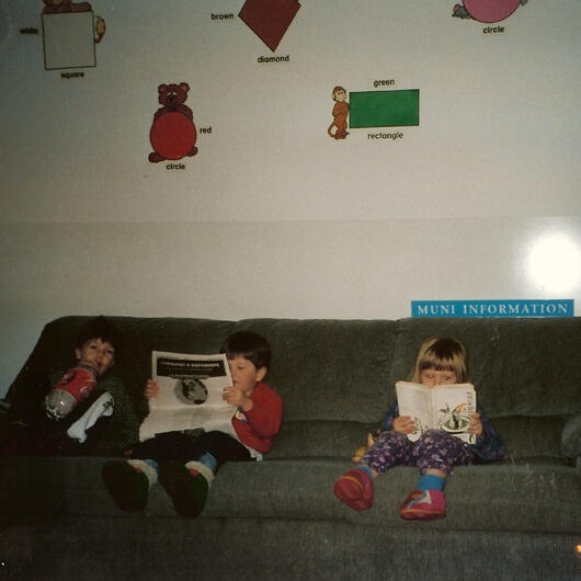 Children reading books on the couch