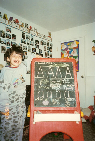 Infants playing with an alphabet activity toy
