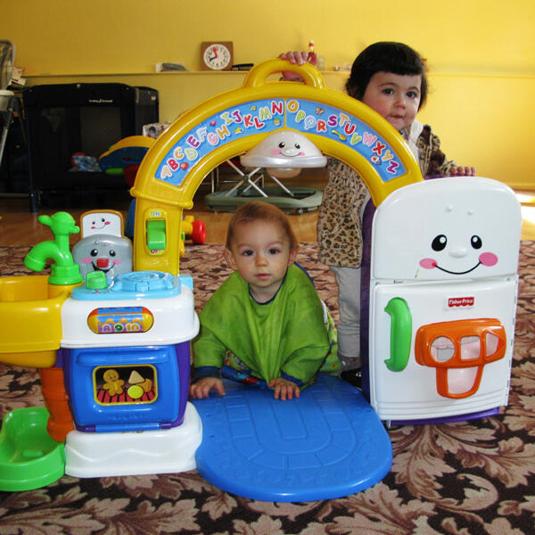 Infants playing with an alphabet activity toy
