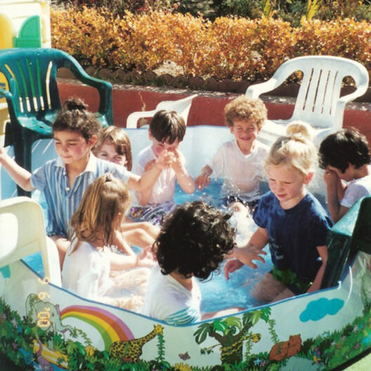 Children enjoying water play in the backyard at Lana's Sunset Preschool