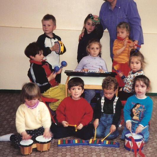 Children playing rhythm instruments together