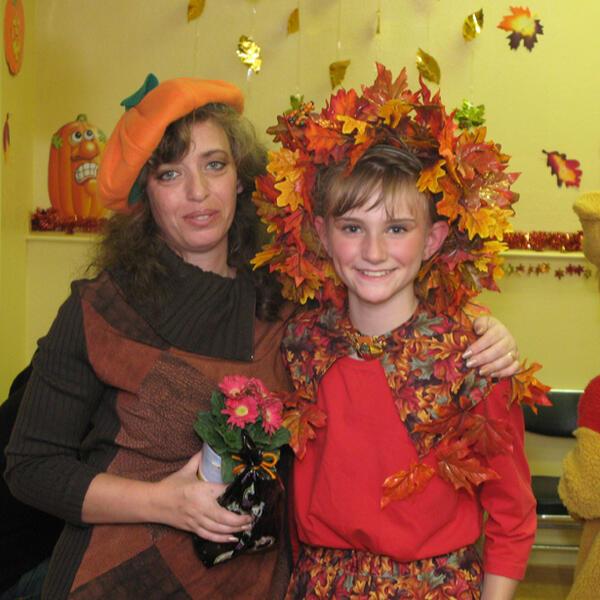 Lana and child in fall performance costumes