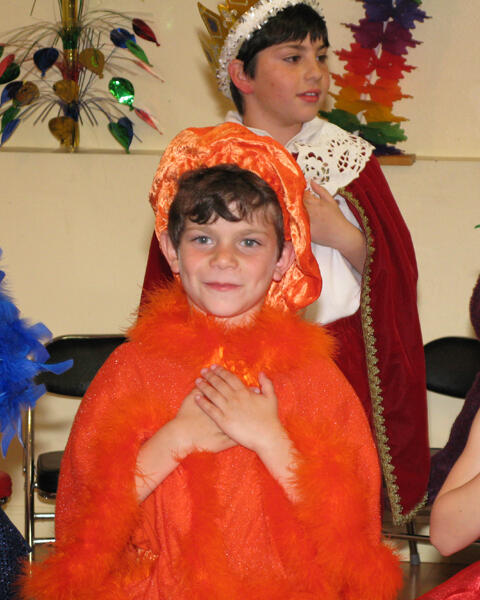 Child in costume with Santa during a holiday celebration