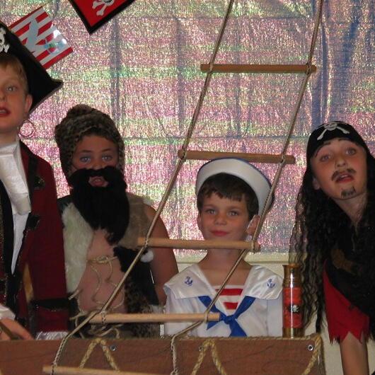 Children performing as pirates and sailors